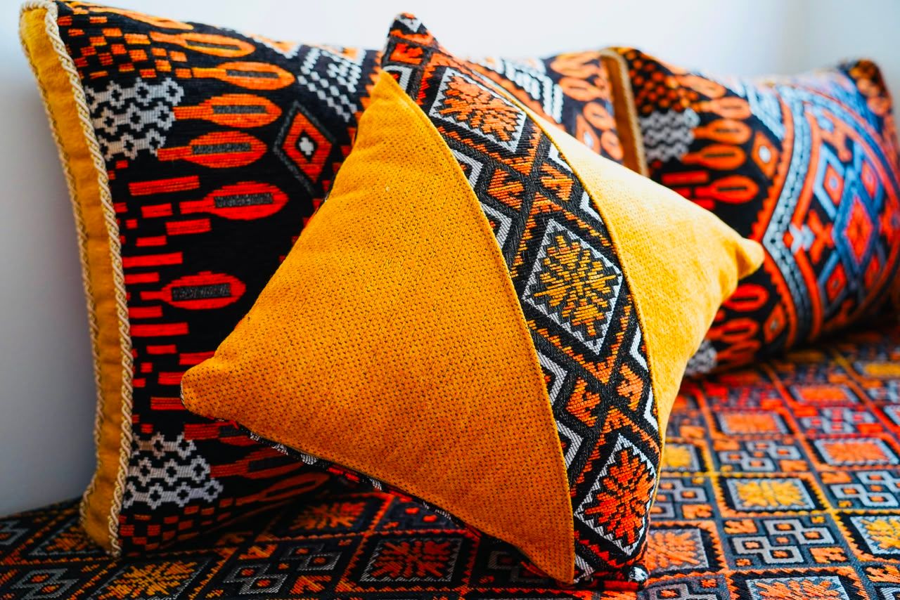 Yellow and patterned cushions on the bench seat